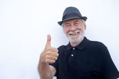 Portrait of man wearing hat against white background