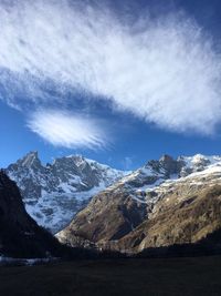 Scenic view of snowcapped mountains against sky at night