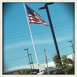Low angle view of power lines against blue sky