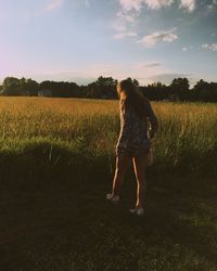 Silhouette of woman standing on field