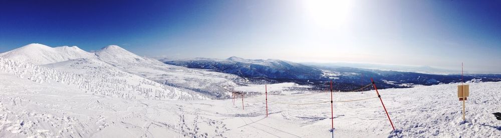 Scenic view of snow covered mountains against cloudy sky