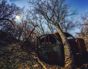 View of old abandoned car on field