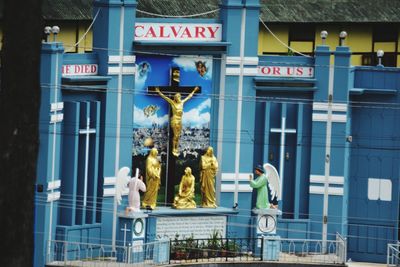 Statue against building in city