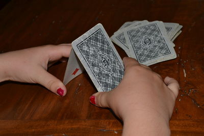 Cropped hands making card castle