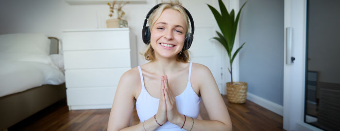 Portrait of young woman sitting at home