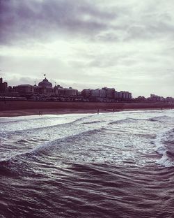 Scenic view of sea against sky in city