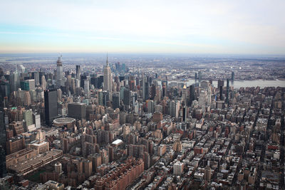 High angle view of modern buildings in city against sky