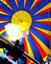 Low angle view of hot air balloon going up with fire