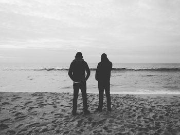Rear view of couple on beach