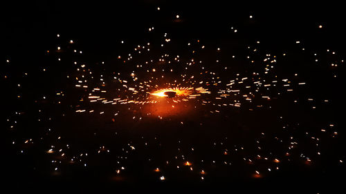 Low angle view of firework display at night