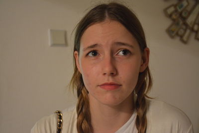 Close-up of teenage girl with braided hair at home