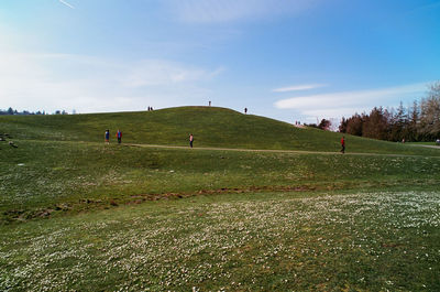 People on field against sky
