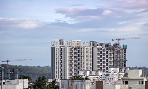 Twin, tall buildings under construction in  maharashtra, india.