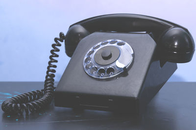 Close-up of telephone booth on table