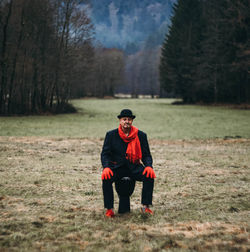 Rear view of man sitting on field