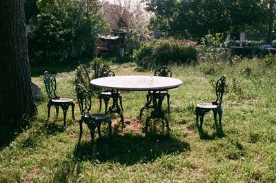 Empty chairs and table in park