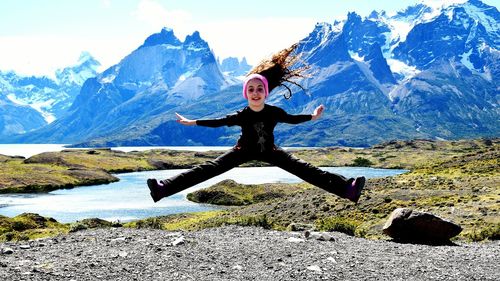 Full length of woman standing on mountain