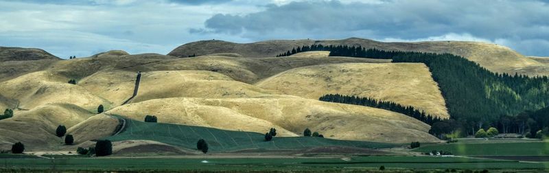 Scenic view of landscape against cloudy sky