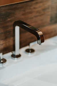 Close-up of faucet in bathroom