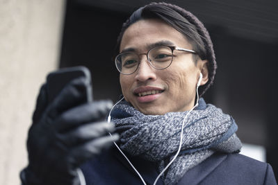 Handsome man with smartphone on street