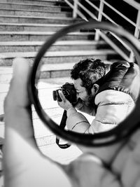 Close-up of man photographing camera