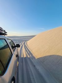 Scenic view of desert against clear blue sky