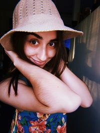 Portrait of smiling young woman wearing hat