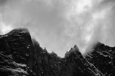 Scenic view of mountains against cloudy sky