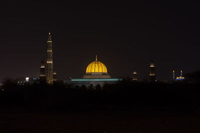 Illuminated building against sky at night