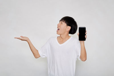 Full length of senior man standing against white background