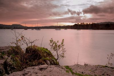 Scenic view of river against cloudy sky