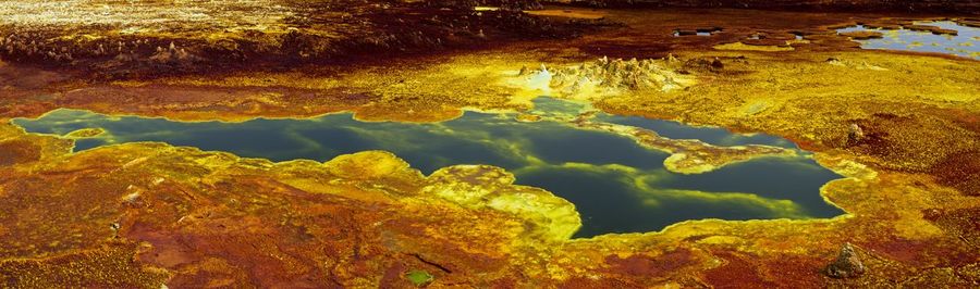 Panorama of surreal colors created by sulphur springs bright colors in danakil depression, ethiopia.