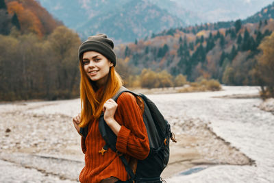 Portrait of smiling young woman standing in winter