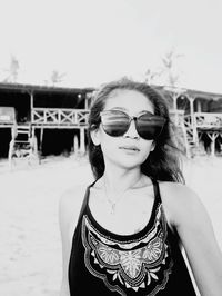 Portrait of woman wearing sunglasses standing outdoors