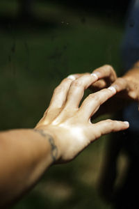 Close-up of hands on mirror