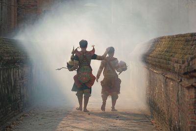 Rear view of people walking on water