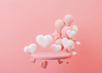 Pink podium with hearts, balloons flying in the air. valentine's day, wedding, anniversary. mockup