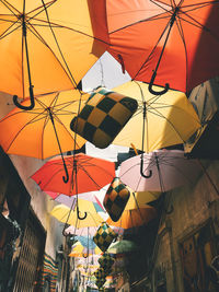 Low angle view of umbrellas hanging at market stall