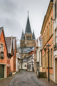 Street amidst buildings against sky