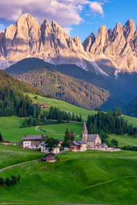 Scenic view of field and mountains against sky