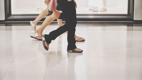 Low section of woman walking on floor