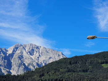 Low angle view of mountain against blue sky