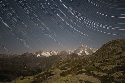 Scenic view of mountains against sky at night