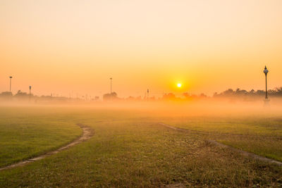 Scenic view of field against sky during sunset