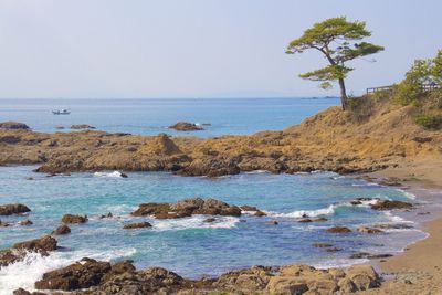 Rock formations in sea against sky