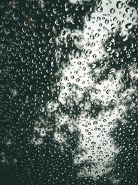 Full frame shot of wet glass window in rainy season