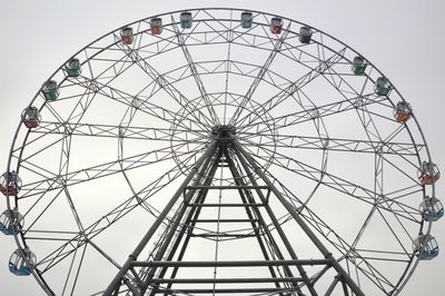 Low angle view of ferris wheel against sky