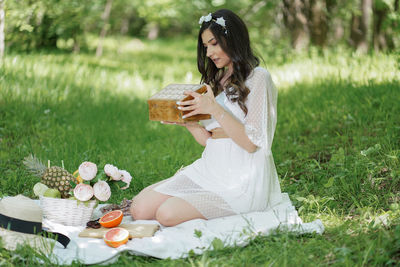 Woman sitting on grassy field