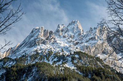 Low angle view of snowcapped mountain against sky