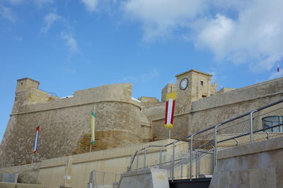 Low angle view of buildings against blue sky